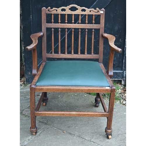 76 - A George III oak open armchair with spindle back and green leather seat, reduced in height