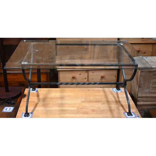 82 - An artisan wrought steel framed glass top coffee table, 11/5 cm x 81.5 cm x 50 cm h