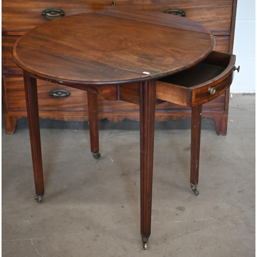 85 - A Georgian cross-banded mahogany drop leaf table, the oval top over a frieze drawer to one end, rais... 