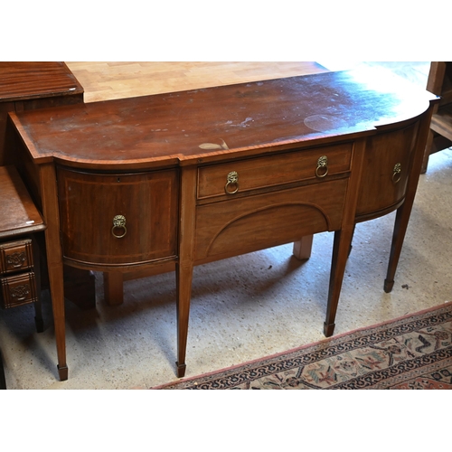 86 - A Victorian mahogany cross-banded breakfront sideboard, centred by a drawer over a shaped apron draw... 