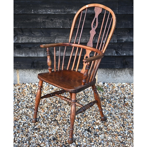 87 - An antique hoop back Windsor elbow chair, one missing spindle