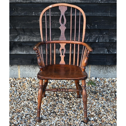 87 - An antique hoop back Windsor elbow chair, one missing spindle