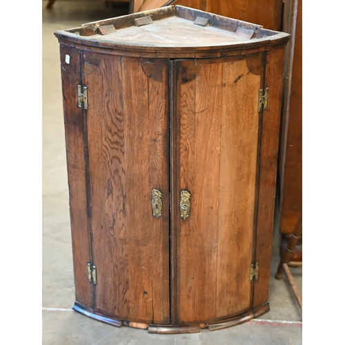 91 - A George III oak barrel front hanging corner cupboard