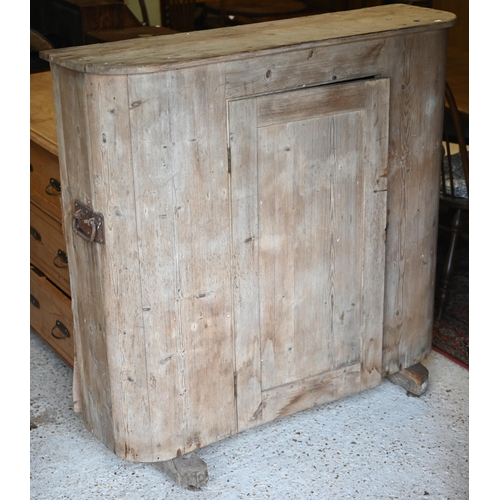 94 - An antique French stripped pine cupboard, with rounded ends centred by a single door, raised on sled... 