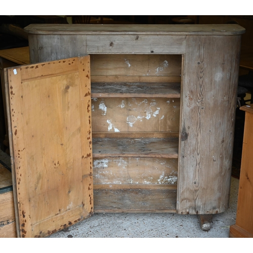 94 - An antique French stripped pine cupboard, with rounded ends centred by a single door, raised on sled... 