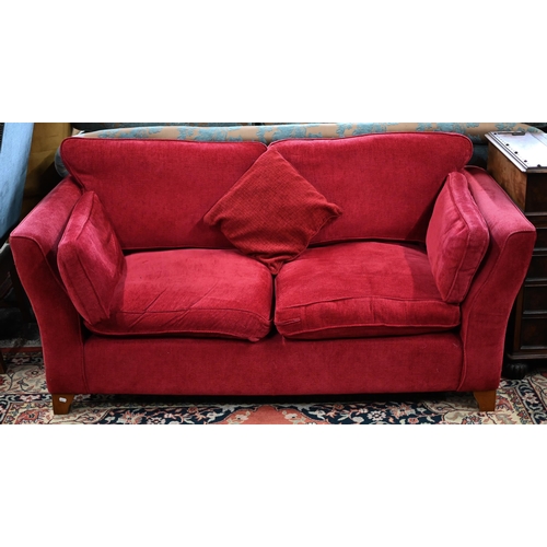 109 - A pair of modern red fabric 'Aldeburgh' two-seater sofas, 180 cm w x 95 cm d x 85 cm hSome fading an... 