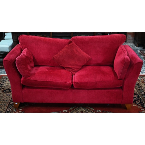 109 - A pair of modern red fabric 'Aldeburgh' two-seater sofas, 180 cm w x 95 cm d x 85 cm hSome fading an... 