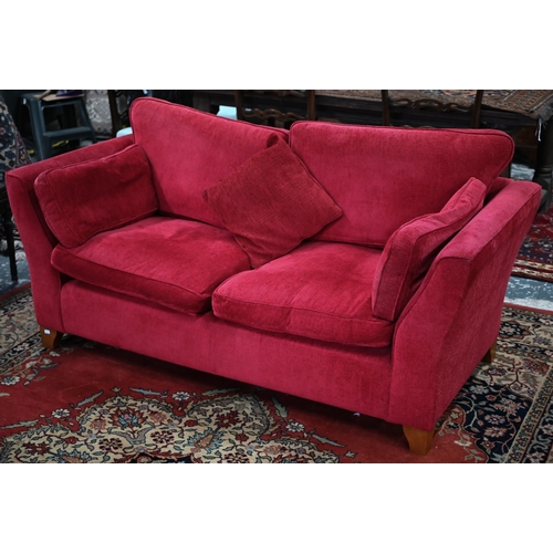 109 - A pair of modern red fabric 'Aldeburgh' two-seater sofas, 180 cm w x 95 cm d x 85 cm hSome fading an... 