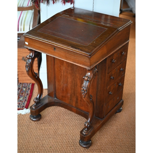 290 - A Victorian rosewood davenport desk, the sloped hinged top inset with brown leather, four side drawe... 