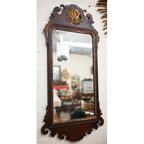 204A - A Georgian wall mirror in fret cut mahogany frame with gilt foliate crest roundel, 93 cm x 50 cm