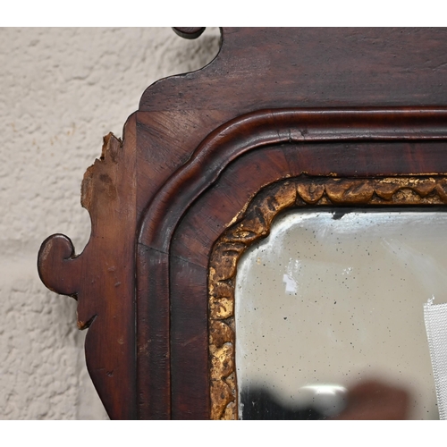 204A - A Georgian wall mirror in fret cut mahogany frame with gilt foliate crest roundel, 93 cm x 50 cm