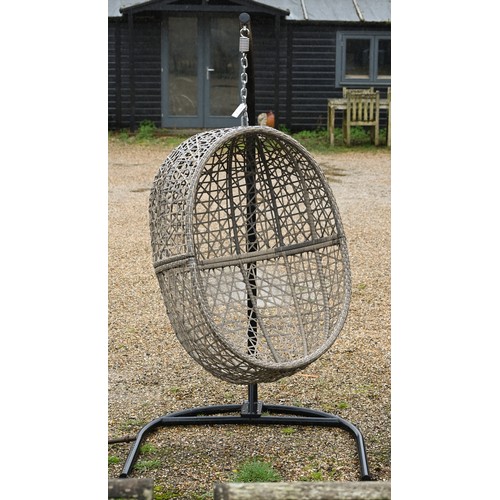 A 'Majestique' woven synthetic rattan hanging garden 'egg' chair on suspension chain from black tubular steel frame, 200 cm high
