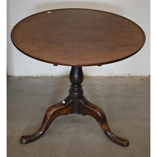 247A - A 19th century mahogany circular tilt-top table on turned column and triform supports, 80 cm diamete... 