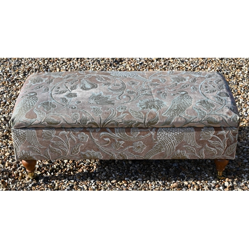 297A - A modern floral upholstered box seated footstool/ottoman on turned supports with brass casters