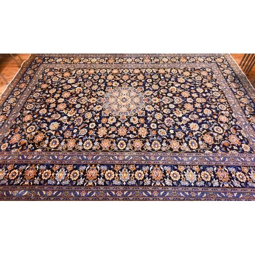 802 - Central Persian signed Kashan carpet, predominantly blue centred by a floral medallion, 380 cm x 270... 