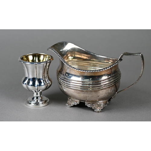 101 - A George III silver milk jug with gadrooned rim and reeded banding, on winged paw feet, Robert Peppi... 