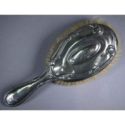 11 - An Edwardian silver-backed hairbrush, Birmingham 1909, to/w a small vase-flute on weighted foot, Bir... 