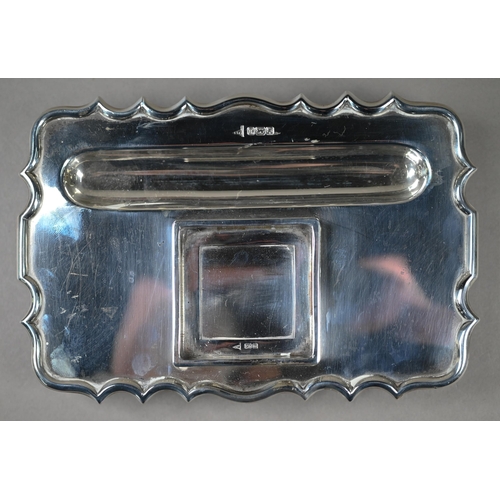 110 - A heavy quality silver inkstand with silver-topped square cut glass inkwell, shaped rim and four scr... 