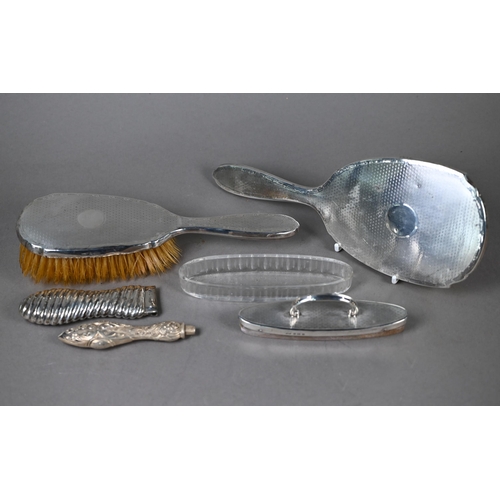 115 - An engine-turned silver hairbrush and mirror set, to/w a similar nail-buffer in glass pot (lacks pad... 