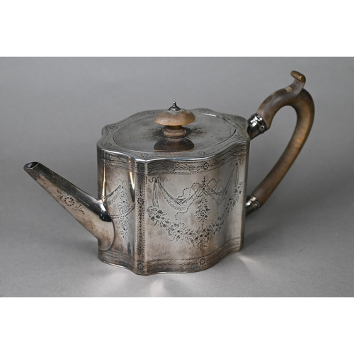 117 - A George III silver teapot of serpentine form with engraved decoration and wooden handle and finial,... 