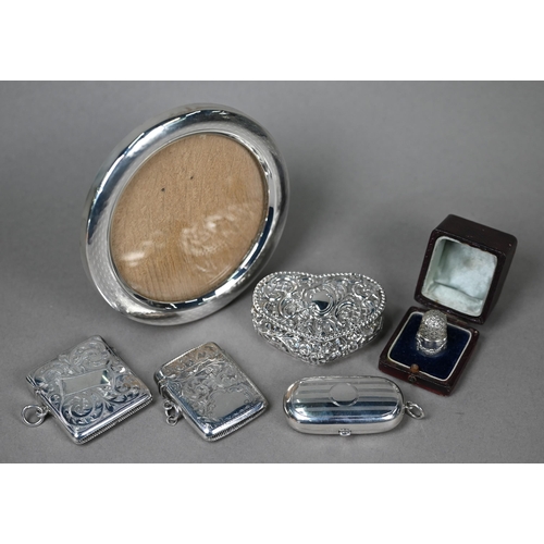 133 - A silver double sovereign case, Henry Williamson Ltd., Birmingham 1913, to/w two foliate-engraved ve... 