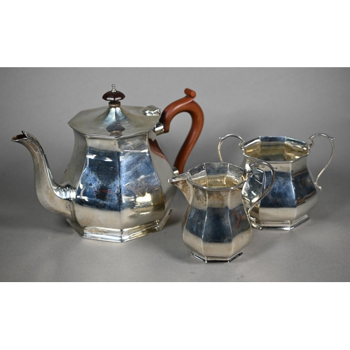 135 - A silver three-piece tea service of octagonal form, the teapot with composite handle and finial, Ale... 