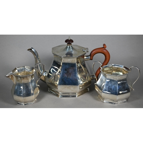 135 - A silver three-piece tea service of octagonal form, the teapot with composite handle and finial, Ale... 