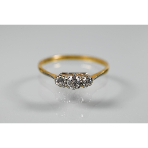 221 - A three-stone diamond ring set 18ct yellow gold, size Q