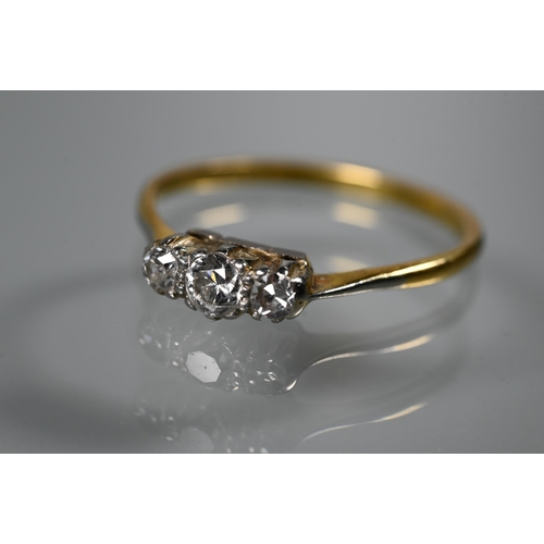 221 - A three-stone diamond ring set 18ct yellow gold, size Q