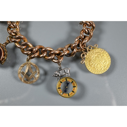 223 - A 9ct curb bracelet with various charms attached including George III guinea, bloodstone and corneli... 