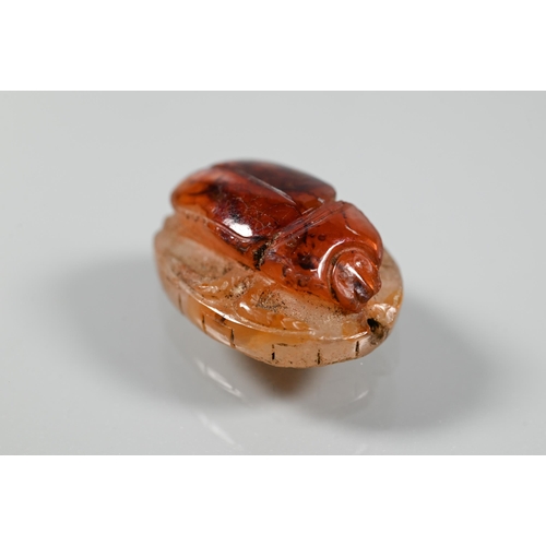 226 - An Etruscan cornelian carved scarab, the base with intaglio featuring fountain within laurel border,... 