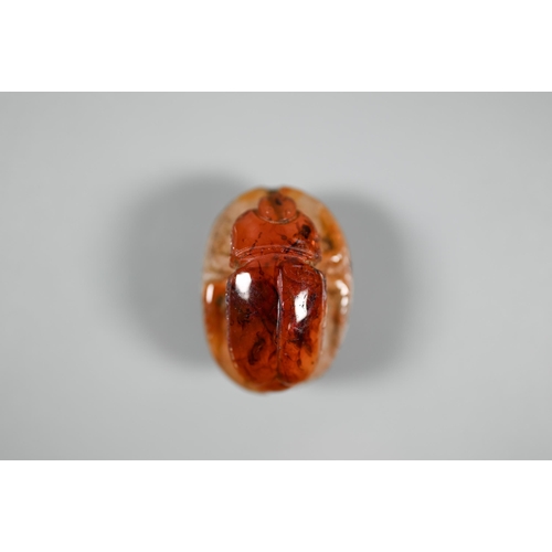 226 - An Etruscan cornelian carved scarab, the base with intaglio featuring fountain within laurel border,... 