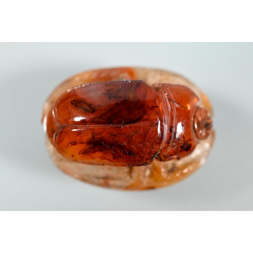 226 - An Etruscan cornelian carved scarab, the base with intaglio featuring fountain within laurel border,... 