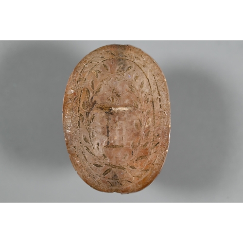 226 - An Etruscan cornelian carved scarab, the base with intaglio featuring fountain within laurel border,... 