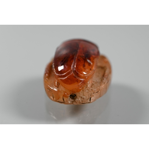 226 - An Etruscan cornelian carved scarab, the base with intaglio featuring fountain within laurel border,... 