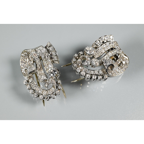 A pair of Italian diamond fur clips, of opposing scroll form mounted overall with mixed cut diamonds, white metal set stamped 750, 3 x 2.5 cm, approx 22.8g all in, in box for Marzot, Venice