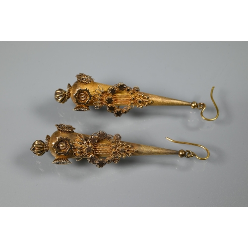 233 - A pair of Victorian textured yellow metal pear-shaped drop earrings with star and foliate motifs, wi... 