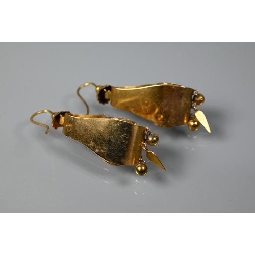 234 - A pair of Victorian textured yellow metal drop earrings of scroll form set with three foil backed st... 