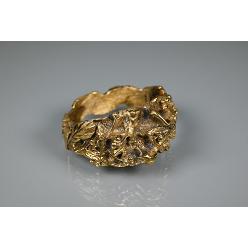 238 - Trifari - A gilt metal bangle of sculptural naturalistic form, half hinged with concealed clasp, 6 c... 