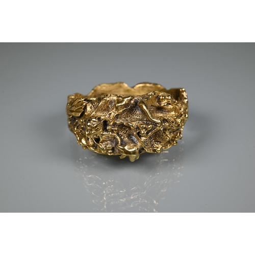 238 - Trifari - A gilt metal bangle of sculptural naturalistic form, half hinged with concealed clasp, 6 c... 