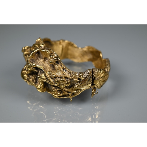 238 - Trifari - A gilt metal bangle of sculptural naturalistic form, half hinged with concealed clasp, 6 c... 