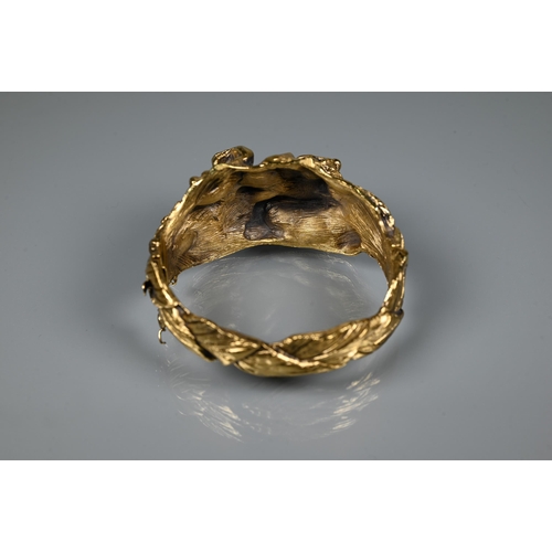 238 - Trifari - A gilt metal bangle of sculptural naturalistic form, half hinged with concealed clasp, 6 c... 