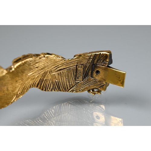 238 - Trifari - A gilt metal bangle of sculptural naturalistic form, half hinged with concealed clasp, 6 c... 