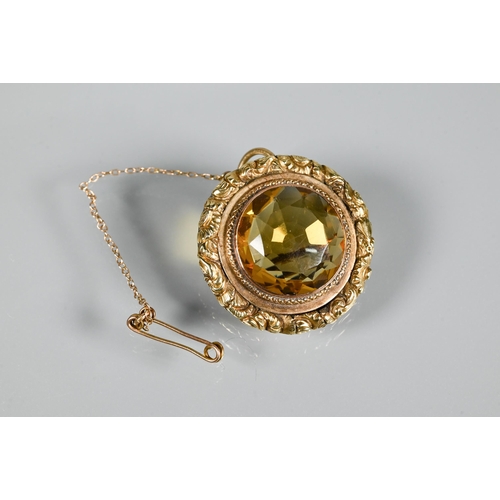 254 - A Victorian roundel brooch with circular citrine to centre with carved border around, 3cm diam ... 