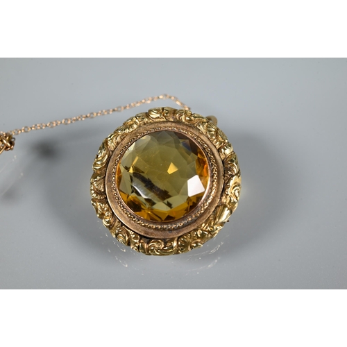 254 - A Victorian roundel brooch with circular citrine to centre with carved border around, 3cm diam ... 