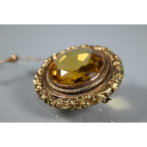 254 - A Victorian roundel brooch with circular citrine to centre with carved border around, 3cm diam ... 