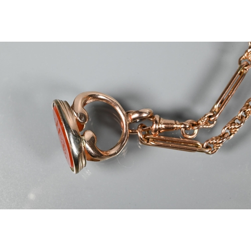 257 - A rose-gold fetter link Albert chain with swivel and cornelian set fob attached, 37 cm long (closed)... 