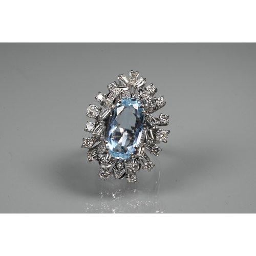 262 - A contemporary statement cluster ring, the oval claw set aquamarine surrounded by an arrangement of ... 