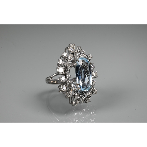 262 - A contemporary statement cluster ring, the oval claw set aquamarine surrounded by an arrangement of ... 