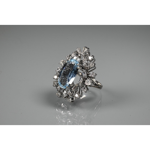 262 - A contemporary statement cluster ring, the oval claw set aquamarine surrounded by an arrangement of ... 